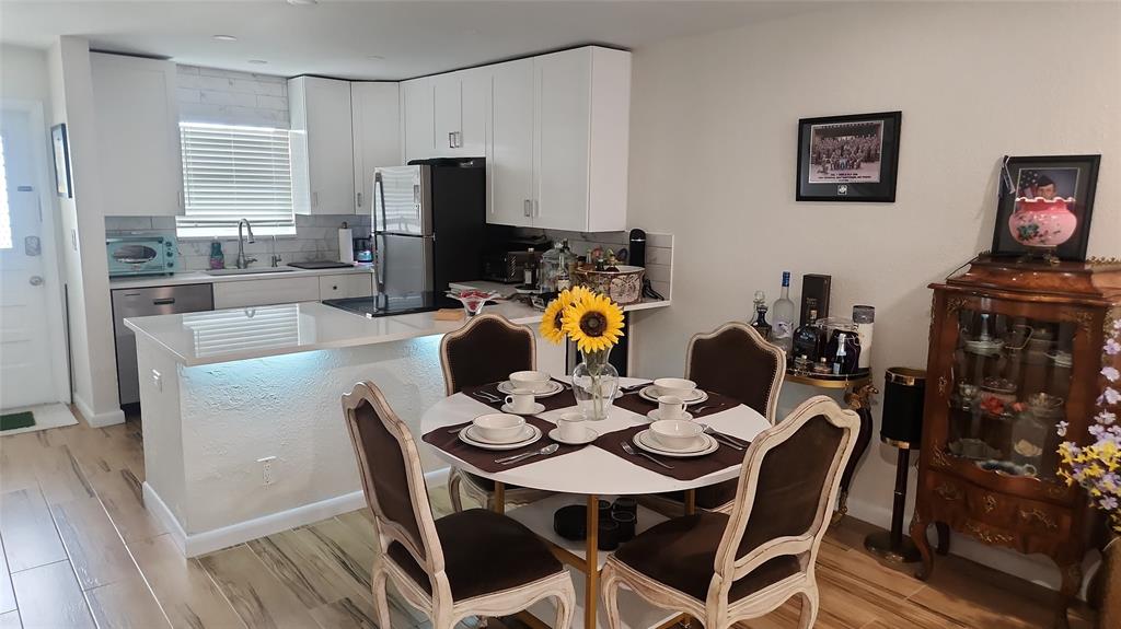 2202 Northeast 36th Street, Unit 15 Lighthouse Point, FL 33064 - Photo 7 of 47 a view of a dining room with furniture and wooden floor