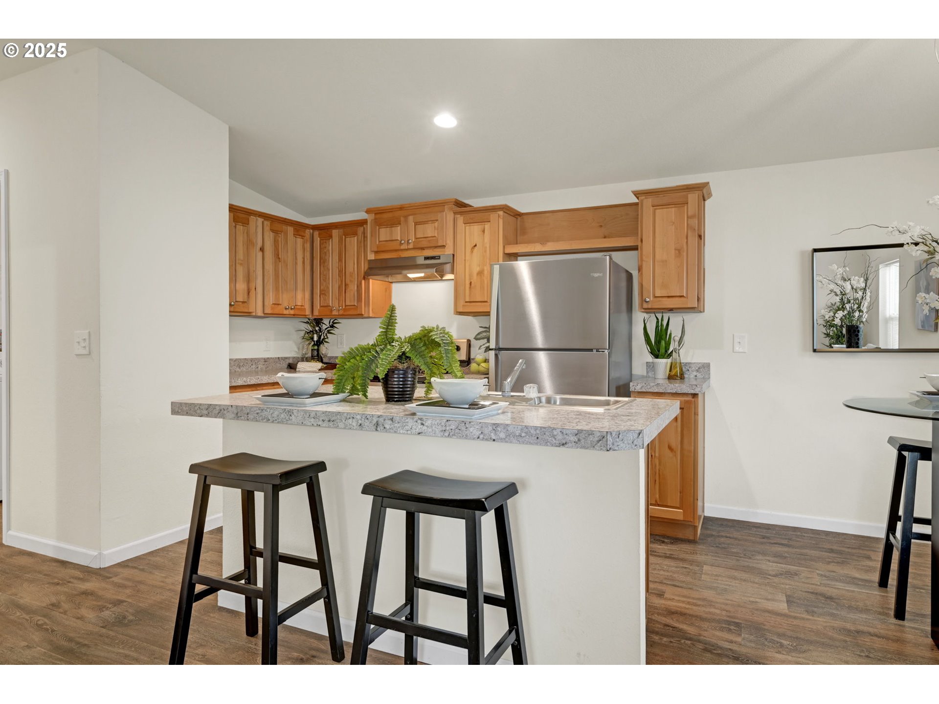 87886 Cedar Flat Road Springfield, OR 97478 - Photo 7 of 34 a kitchen with stainless steel appliances kitchen island granite countertop a table and chairs in it