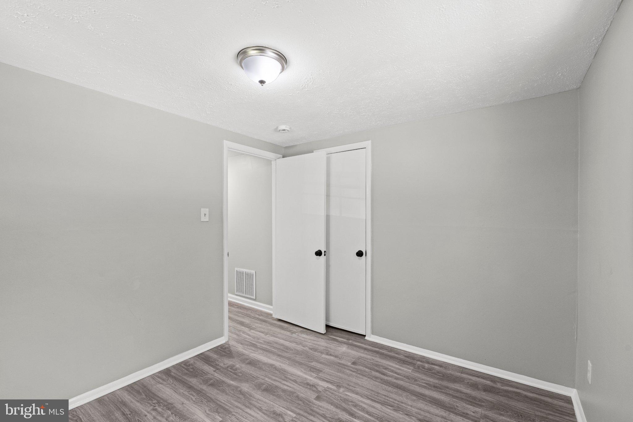 8405 Shirley Road Spotsylvania, VA 22551 - Photo 19 of 42 a view of an empty room with wooden floor