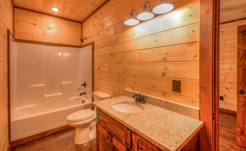 57 Devin Drive Murphy, NC 28906 - Photo 22 of 36 a bathroom with a granite countertop sink toilet and shower