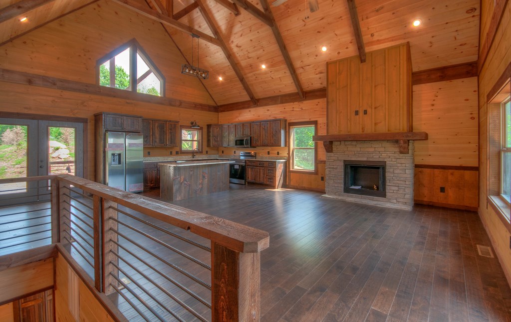 57 Devin Drive Murphy, NC 28906 - Photo 7 of 36 a view of a living room a kitchen with furniture a fireplace and wooden floor
