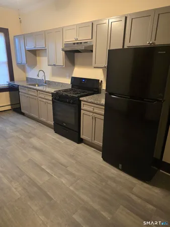 a kitchen with a refrigerator and a sink