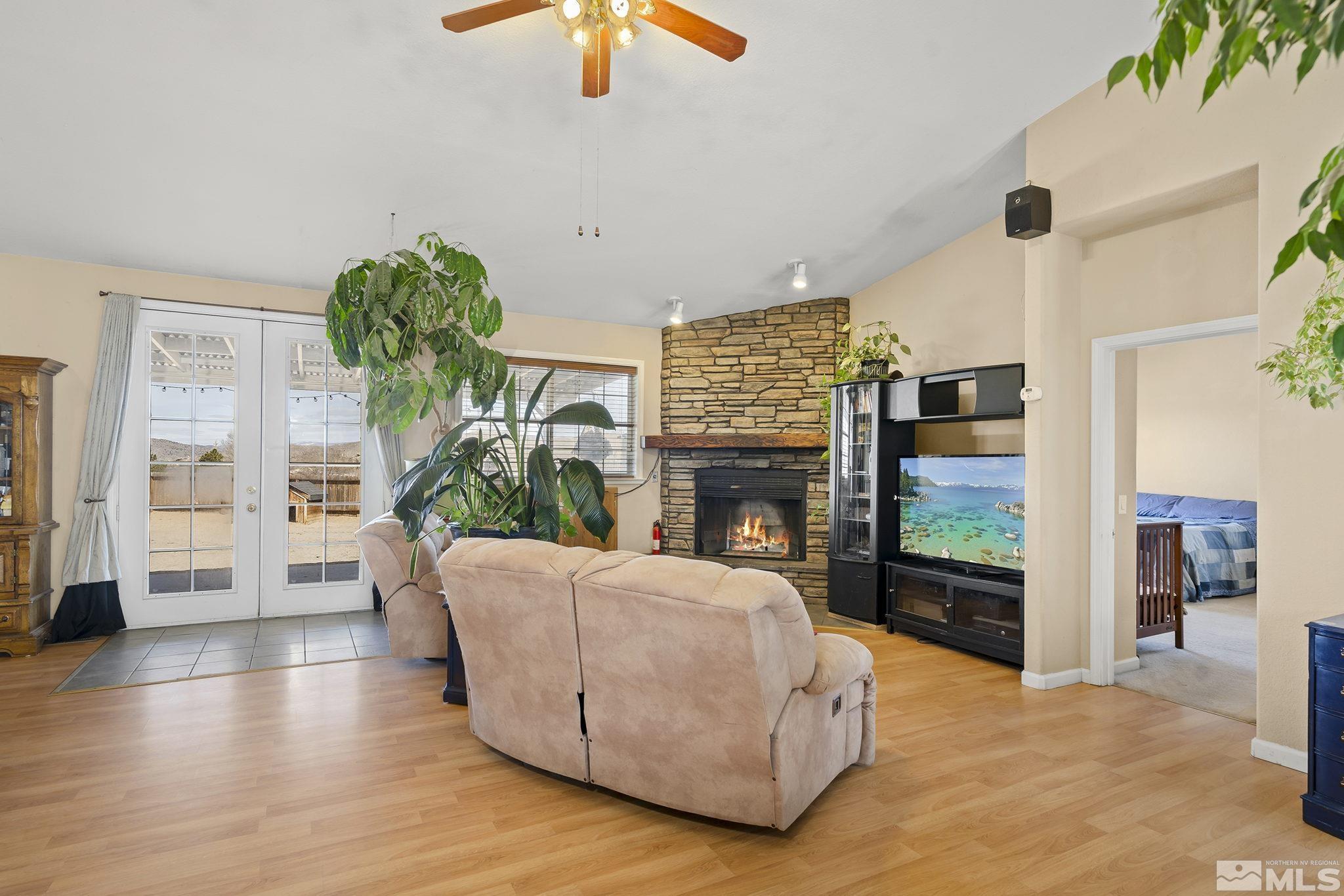8650 Wise Reno, NV 89506 - Photo 3 of 25 a living room with furniture a fireplace and a flat screen tv