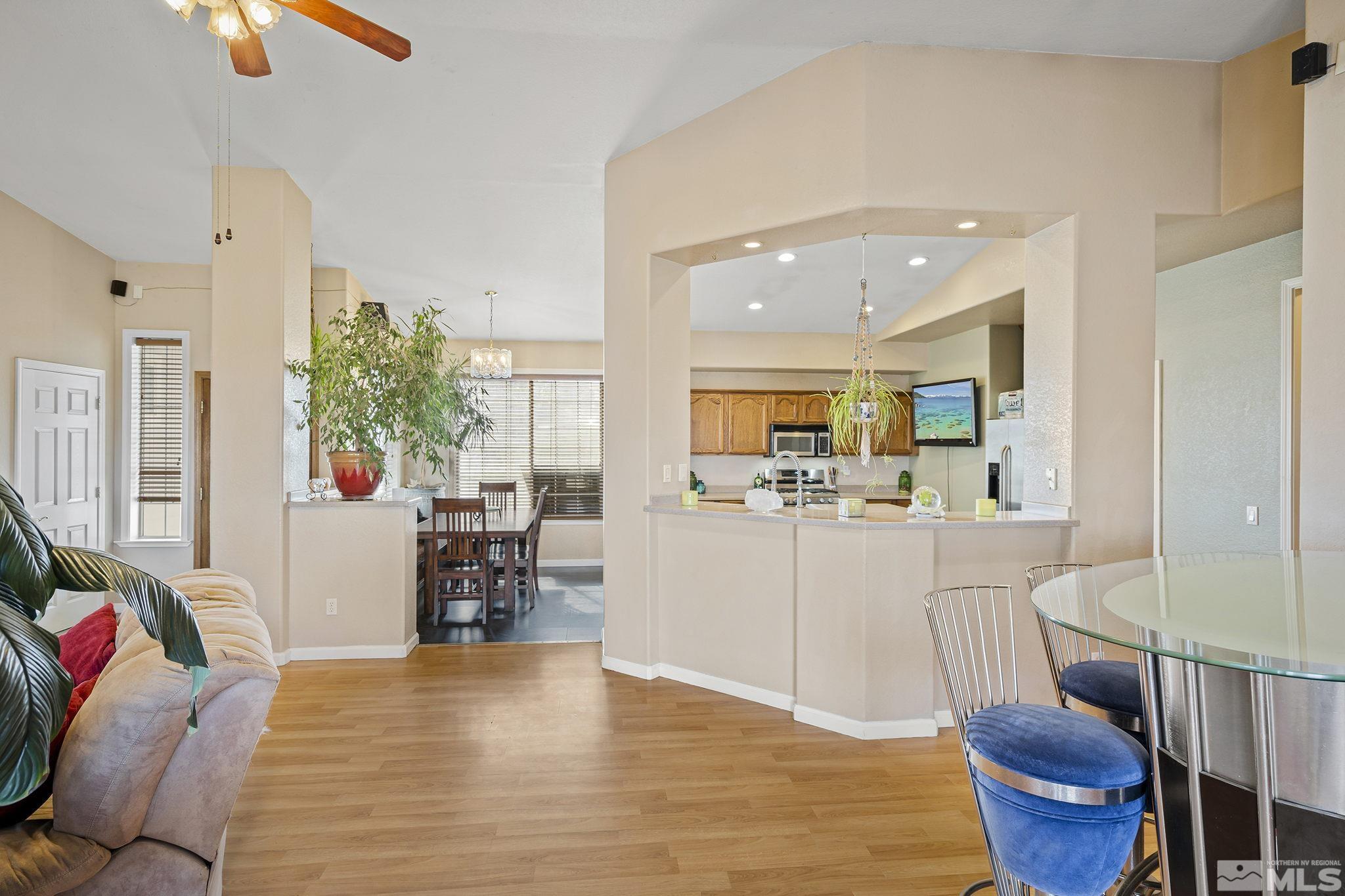 8650 Wise Reno, NV 89506 - Photo 6 of 25 a living room with furniture a dining table and chairs with wooden floor