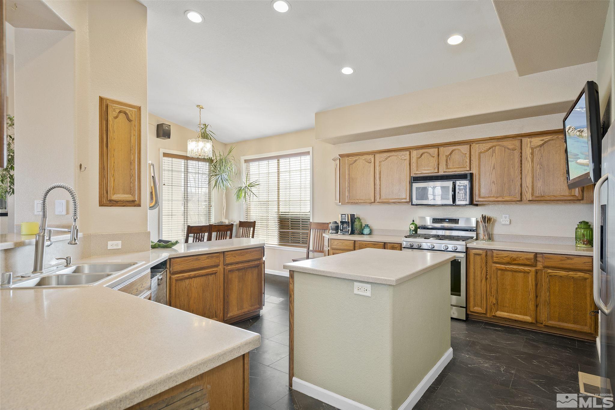 8650 Wise Reno, NV 89506 - Photo 7 of 25 a kitchen that has a sink a stove counter top space and cabinets