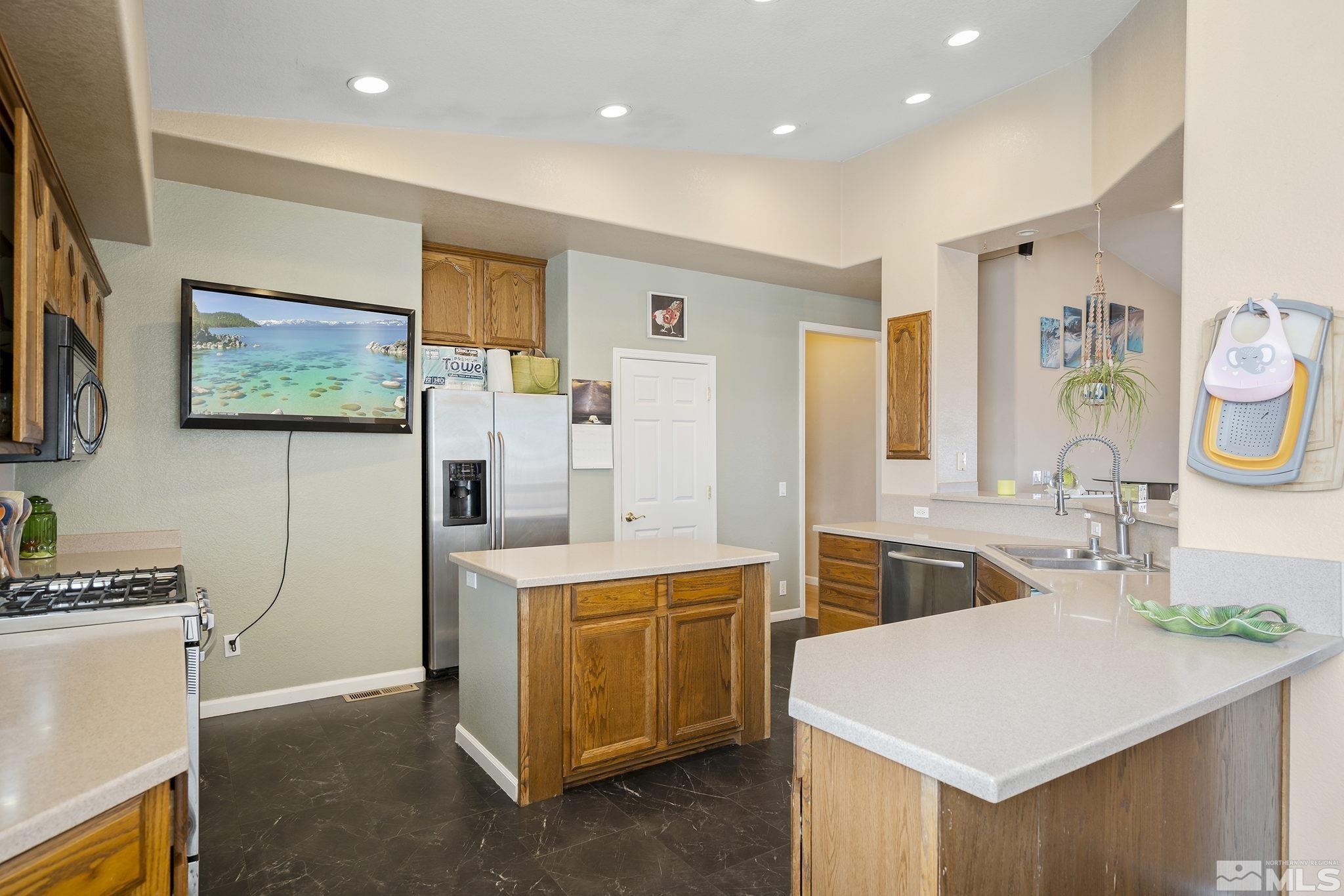 8650 Wise Reno, NV 89506 - Photo 8 of 25 a kitchen that has a sink a stove and a refrigerator