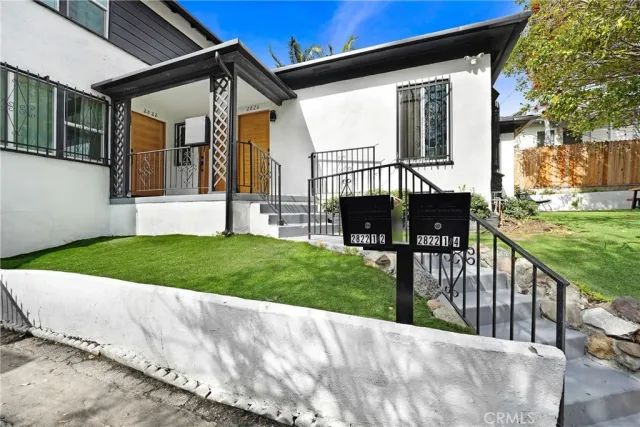 a view of a house with backyard and porch