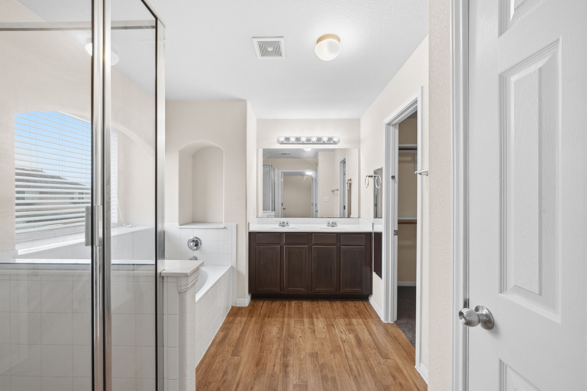 601 Silver Wing Drive Austin, TX 78725 - Photo 13 of 15 a bathroom with a sink a mirror and a bathtub