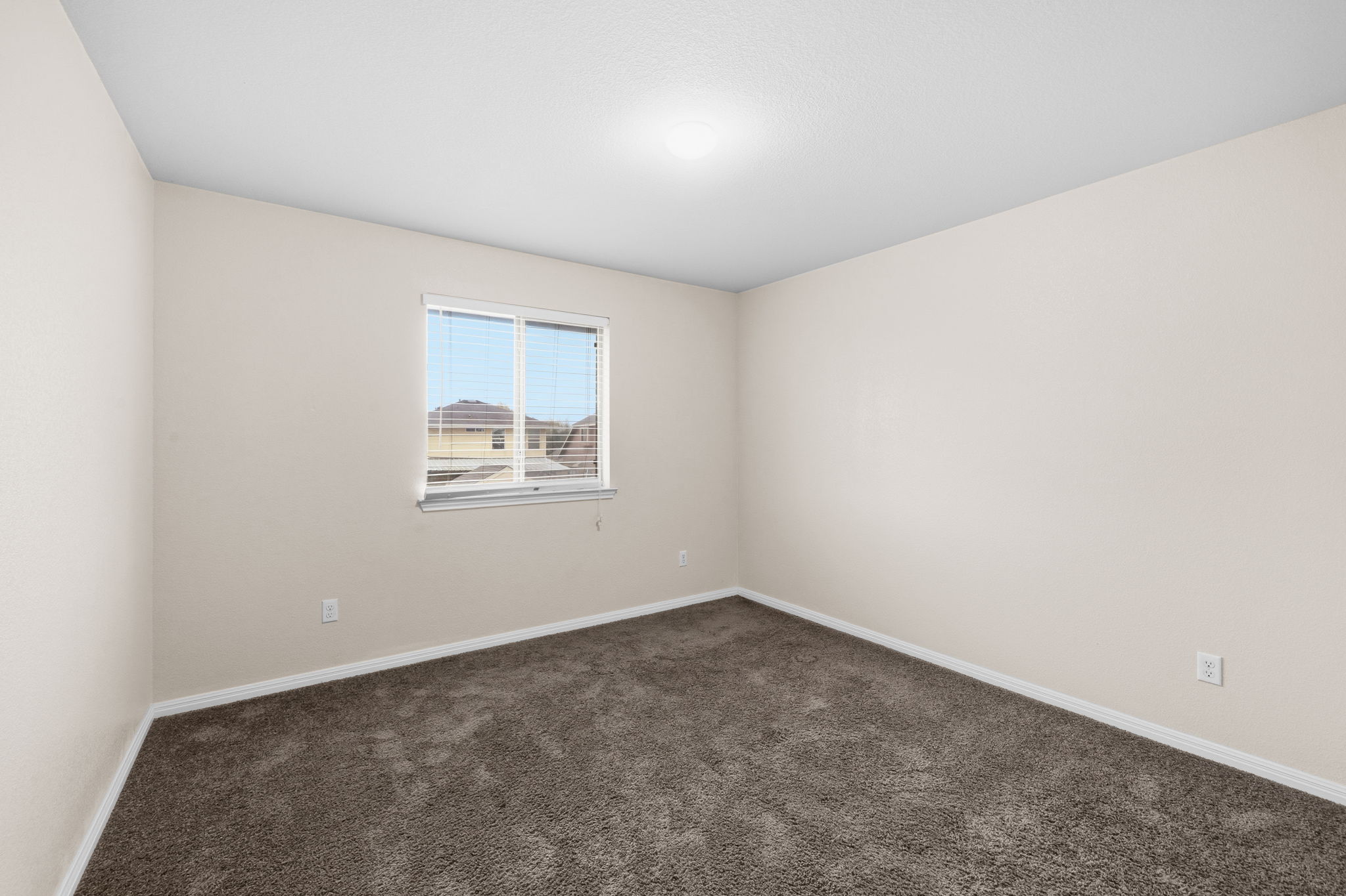 601 Silver Wing Drive Austin, TX 78725 - Photo 10 of 15 an empty room with a empty space and window