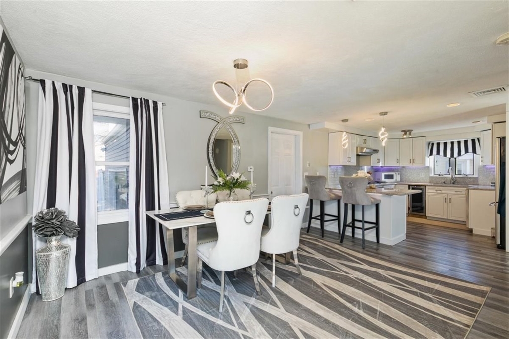 11 Andover Street Danvers, MA 01923 - Photo 12 of 41 a view of a dining room with furniture and a floor to ceiling window