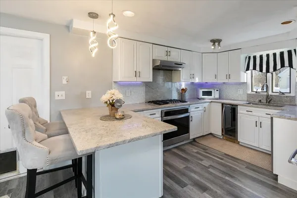 a kitchen with a white cabinets and white appliances
