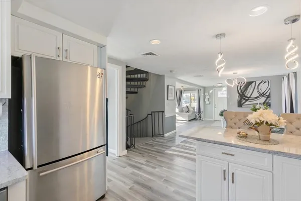 a kitchen with stainless steel appliances a refrigerator and a sink