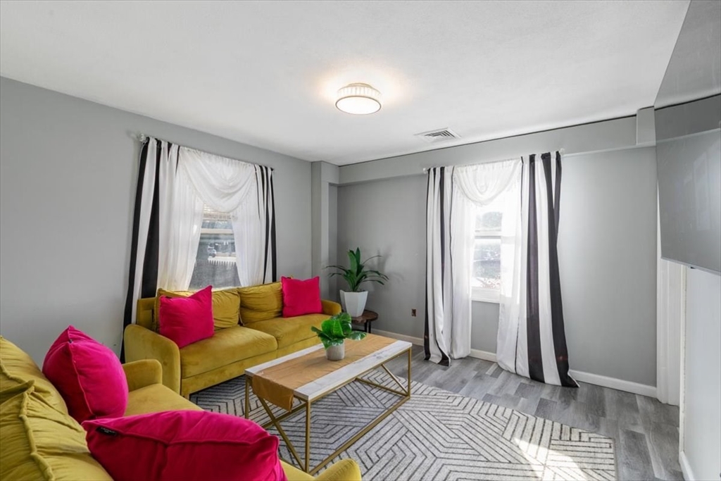 11 Andover Street Danvers, MA 01923 - Photo 17 of 41 a living room with furniture and a potted plant