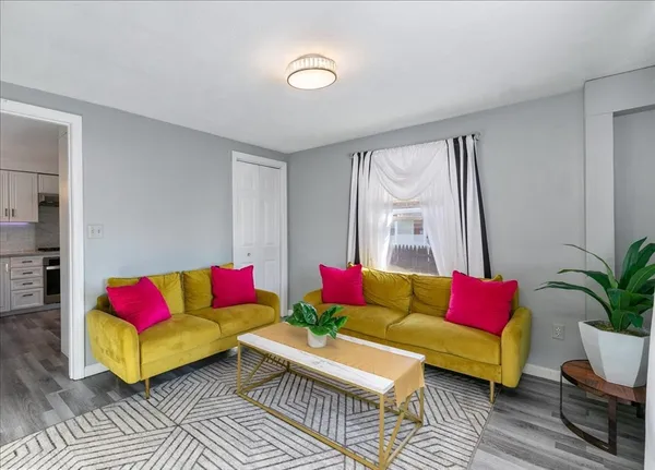 a living room with furniture and a potted plant
