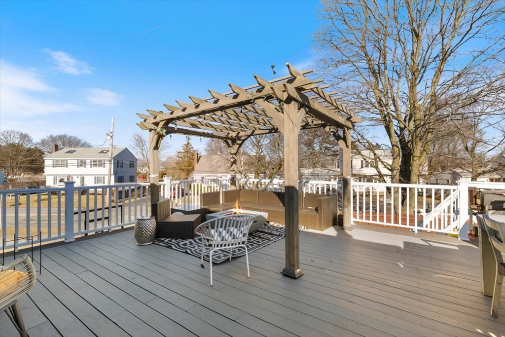 11 Andover Street Danvers, MA 01923 - Photo 25 of 41 a view of a roof deck with table and chairs and wooden floor