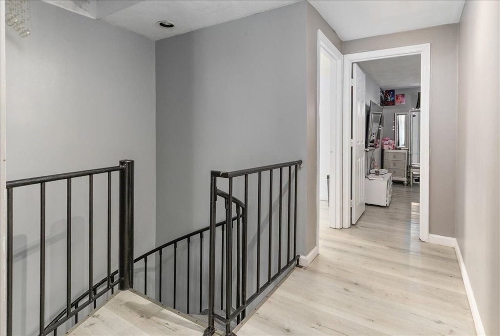 11 Andover Street Danvers, MA 01923 - Photo 27 of 41 a view of a hallway with wooden floor and a bathroom