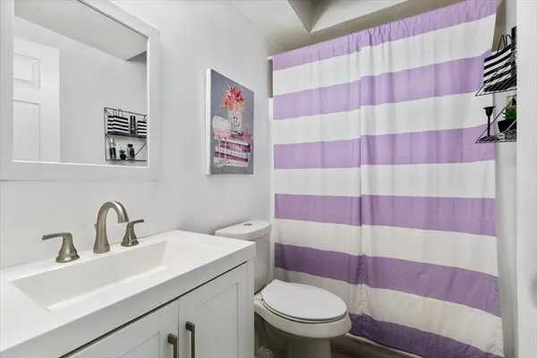 a white bed sitting in a bedroom next to a window