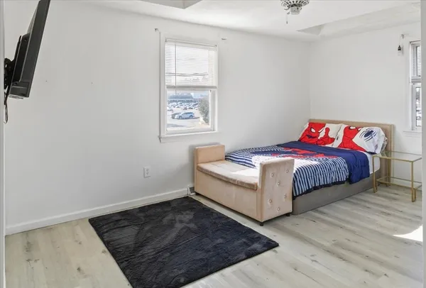 a view of a room with wooden floor and furniture