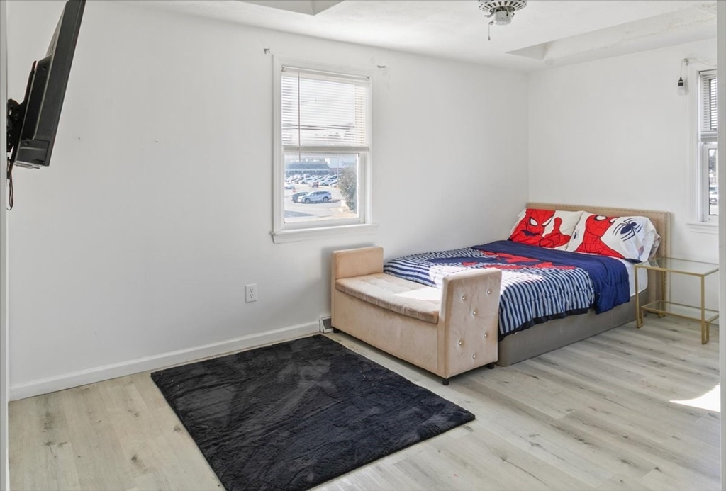 11 Andover Street Danvers, MA 01923 - Photo 30 of 41 a white bed sitting in a bedroom next to a window