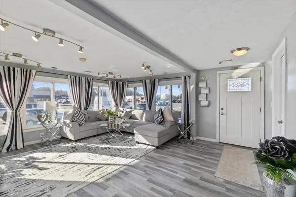 a living room with furniture and wooden floor