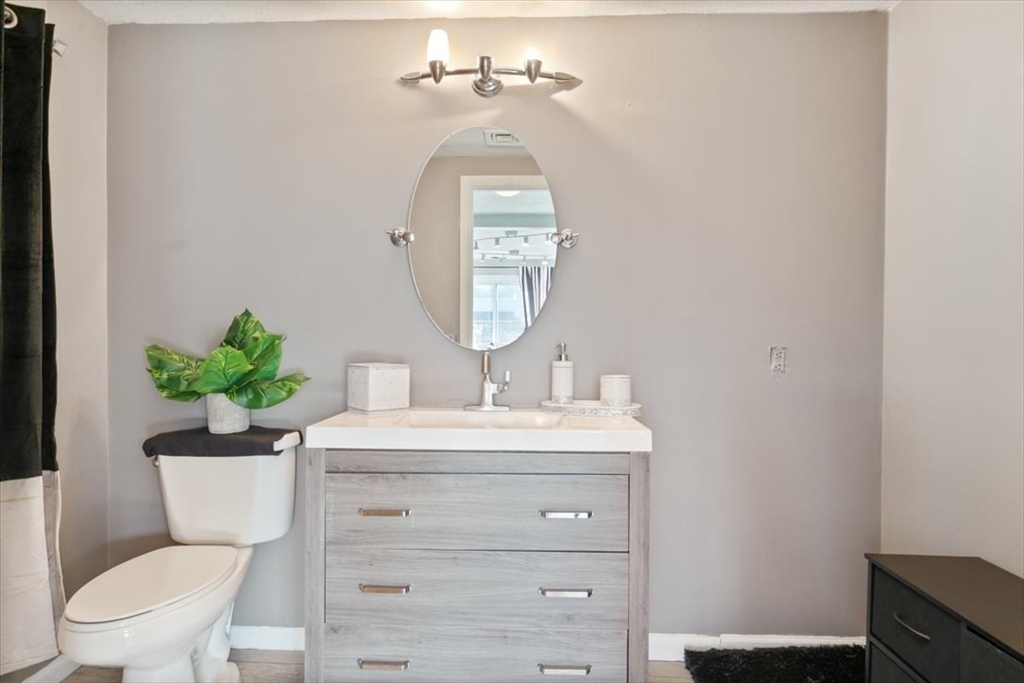 11 Andover Street Danvers, MA 01923 - Photo 10 of 41 a bathroom with a toilet a sink and a mirror