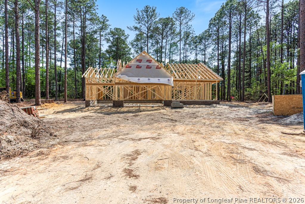 26720 Peach Orchard Road Wagram, NC 28396 - Photo 12 of 18 a view of a house with a snow in the yard
