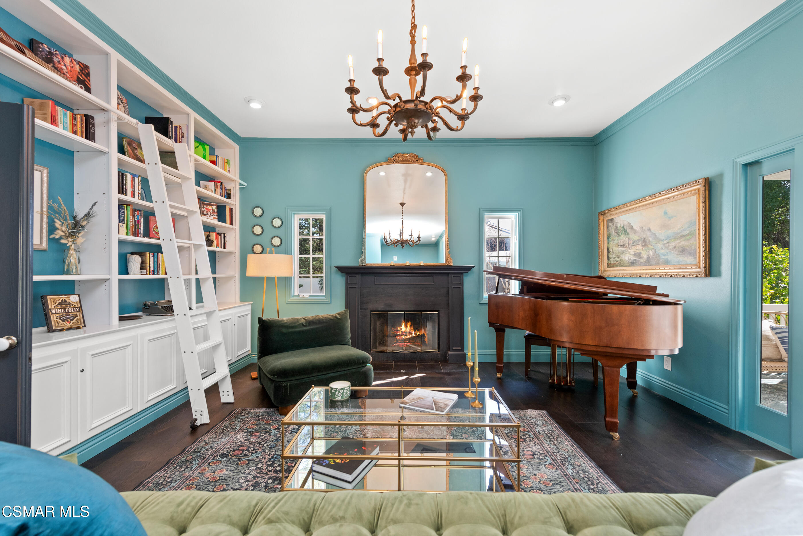 6144 Chesebro Road Agoura Hills, CA 91301 - Photo 27 of 73 a living room with furniture a fireplace and a chandelier