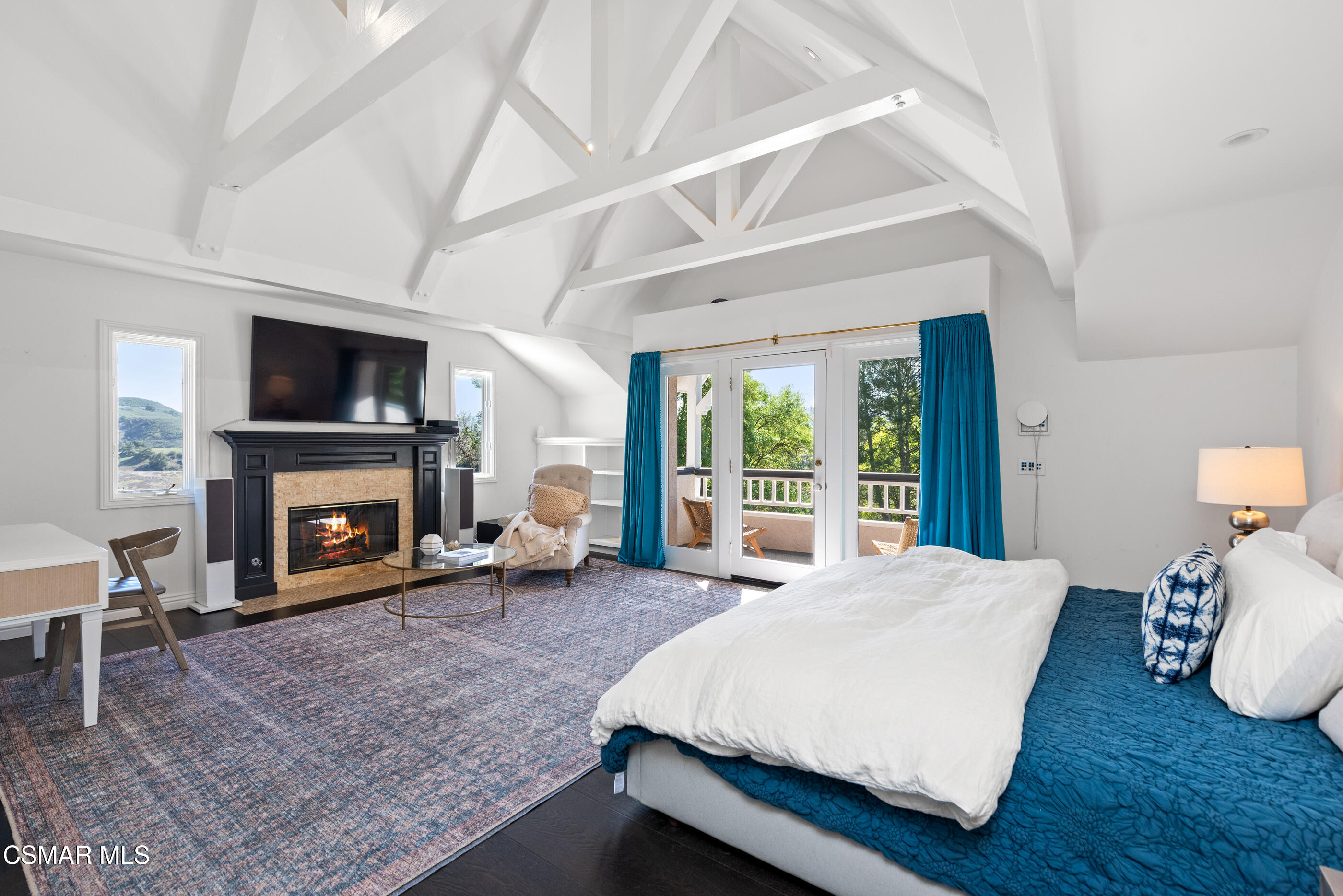 6144 Chesebro Road Agoura Hills, CA 91301 - Photo 30 of 73 a spacious bedroom with a bed and a fireplace