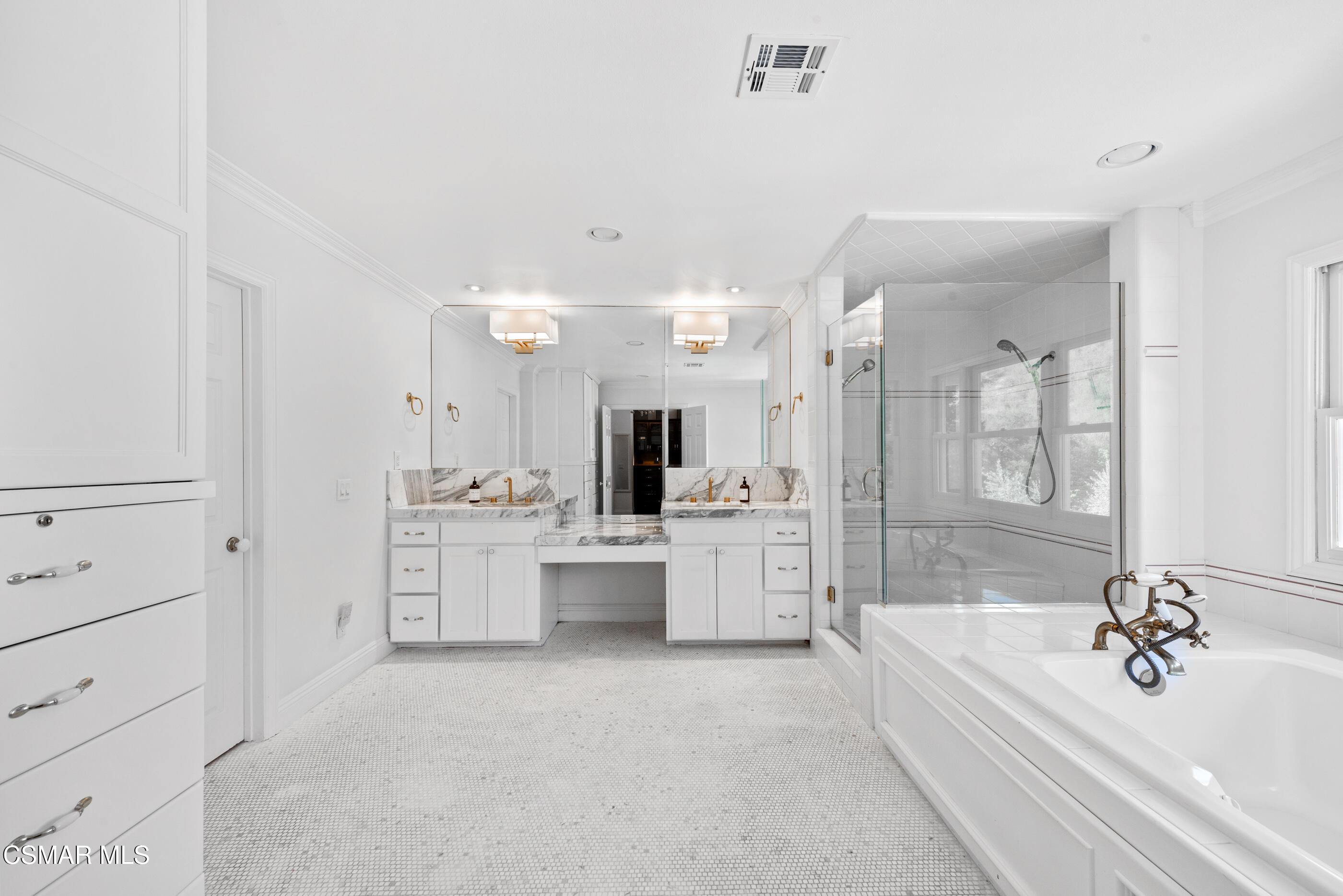 6144 Chesebro Road Agoura Hills, CA 91301 - Photo 32 of 73 a bathroom with a bathtub a double vanity sink a vanity a mirror and a shower