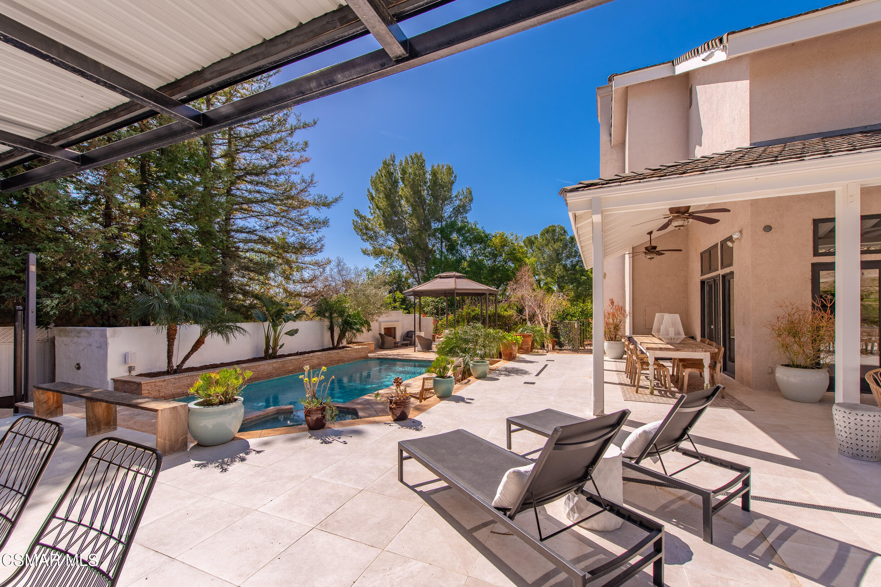 6144 Chesebro Road Agoura Hills, CA 91301 - Photo 43 of 73 a view of a patio with a table and chairs under an umbrella