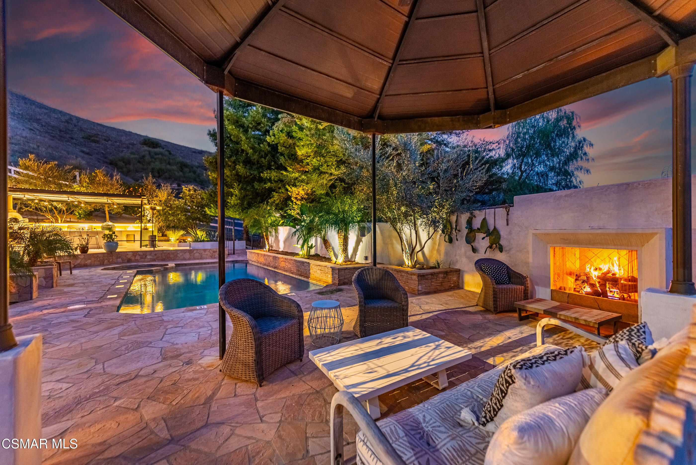 6144 Chesebro Road Agoura Hills, CA 91301 - Photo 5 of 73 a view of a patio with table and chairs under an umbrella