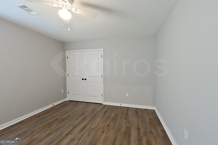 132 Cottage Grove Road Brunswick, GA 31525 - Photo 9 of 17 a view of a room with wooden floor and ceiling fan