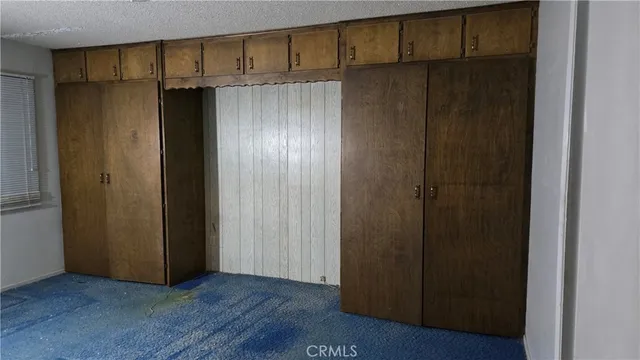 a view of a hallway with wooden shelves