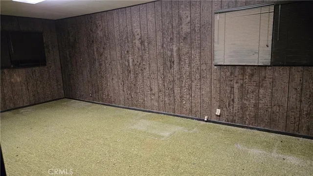 a view of an empty room with wooden walls