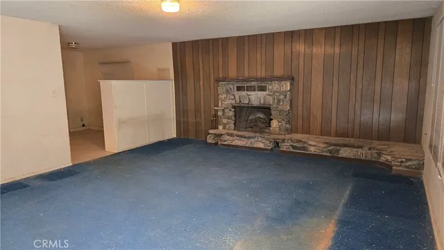 an empty room with a fireplace