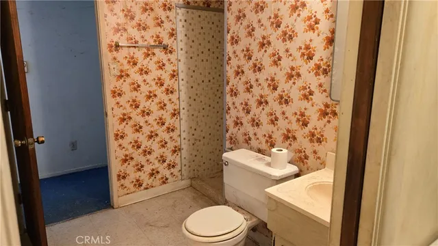 a white toilet sitting next to a shower curtain