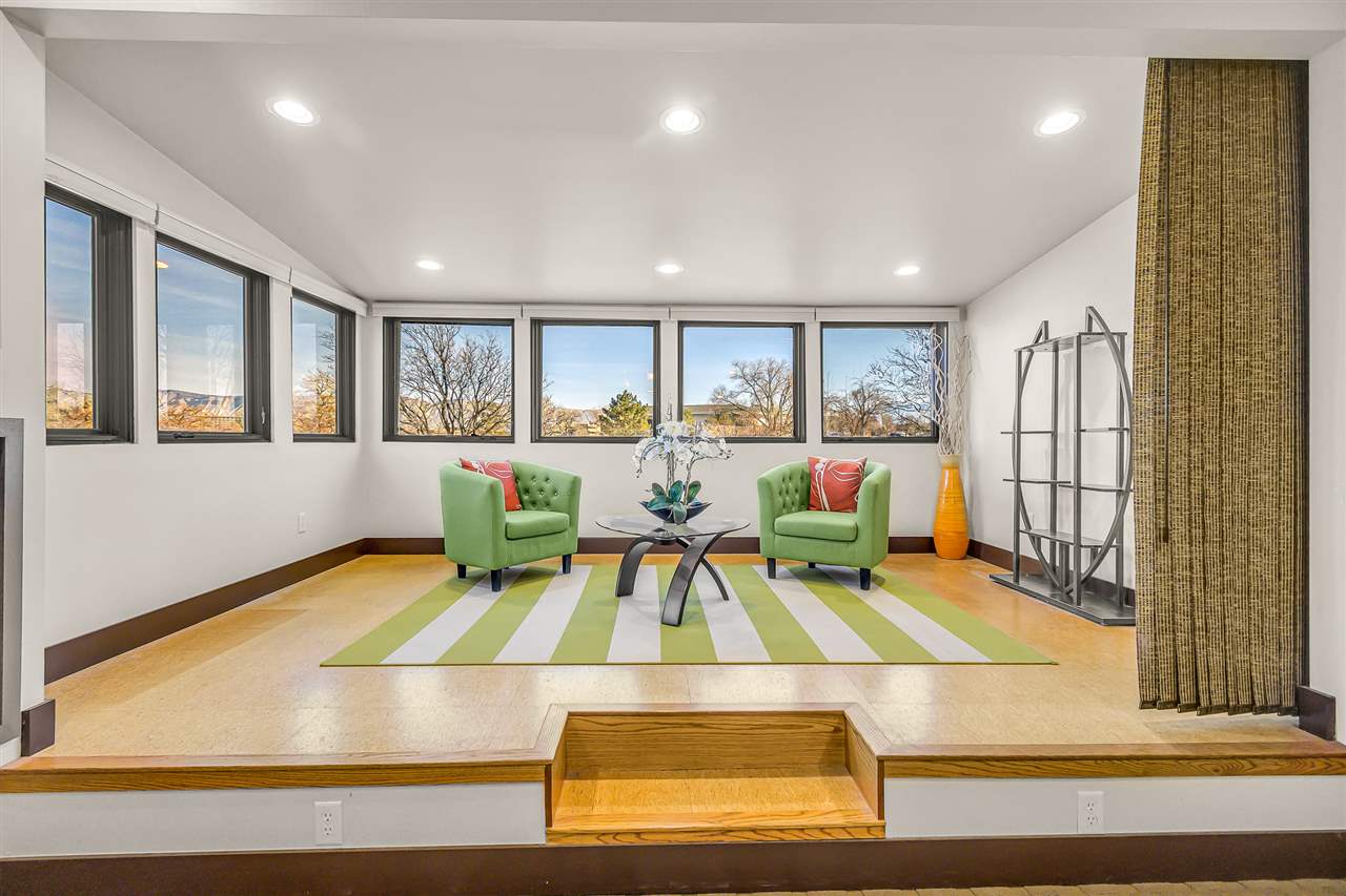 702 Golfmore Drive, Unit C Grand Junction, CO 81506 - Photo 16 of 21 a living room with pool table and floor to ceiling window