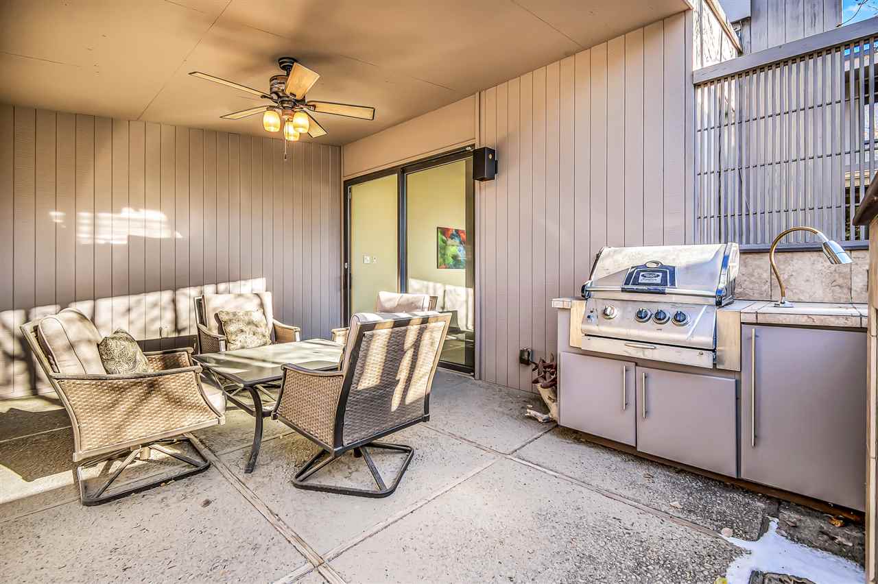 702 Golfmore Drive, Unit C Grand Junction, CO 81506 - Photo 20 of 21 a view of a dining room with furniture and chandelier