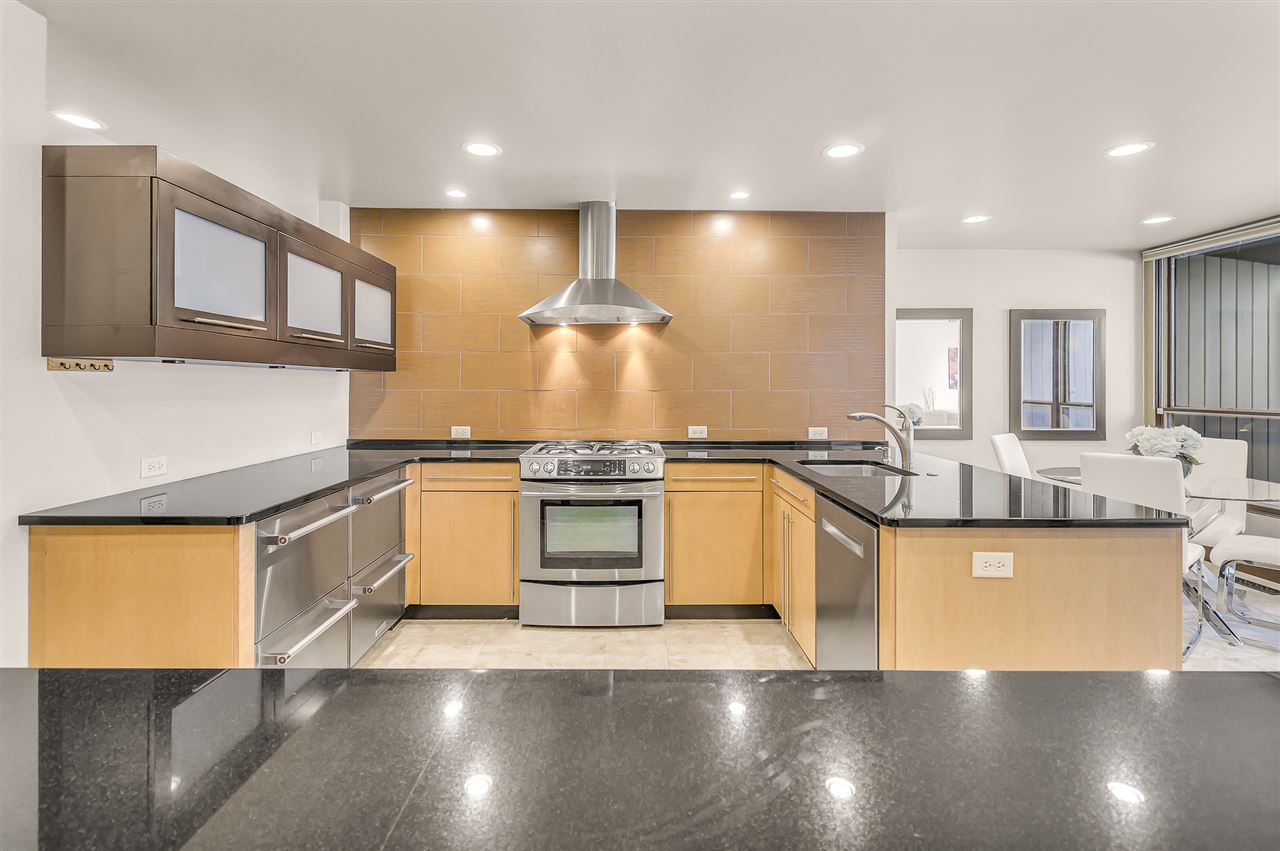 702 Golfmore Drive, Unit C Grand Junction, CO 81506 - Photo 2 of 21 a large kitchen with stainless steel appliances granite countertop a stove and a sink