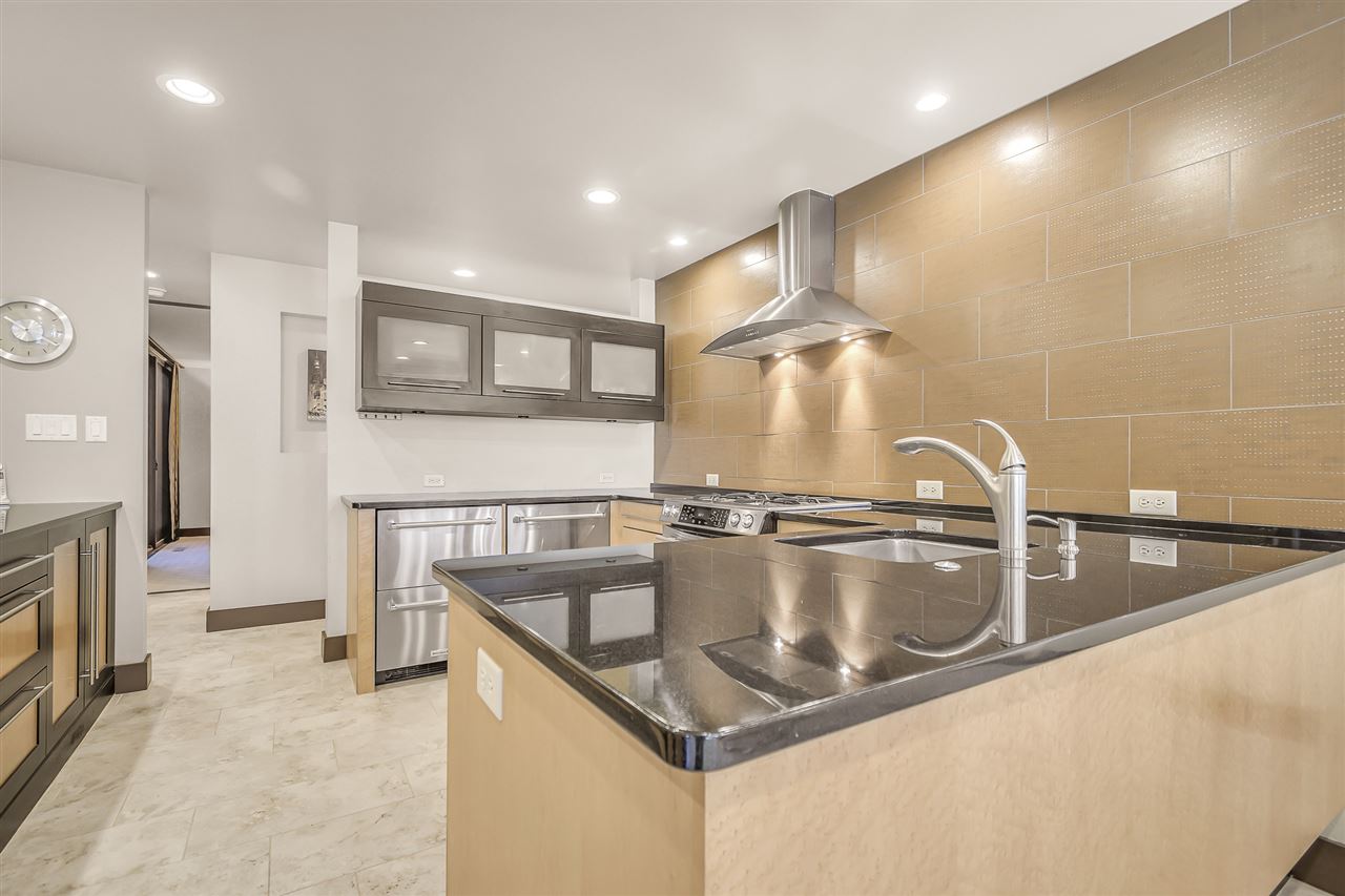 702 Golfmore Drive, Unit C Grand Junction, CO 81506 - Photo 3 of 21 a kitchen with a sink a counter top space cabinets and stainless steel appliances