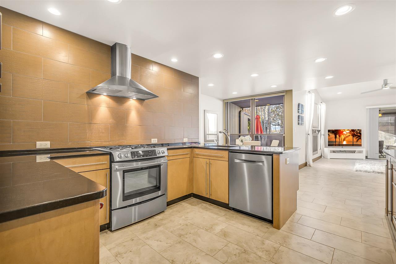 702 Golfmore Drive, Unit C Grand Junction, CO 81506 - Photo 4 of 21 a kitchen with stainless steel appliances granite countertop a stove and a refrigerator