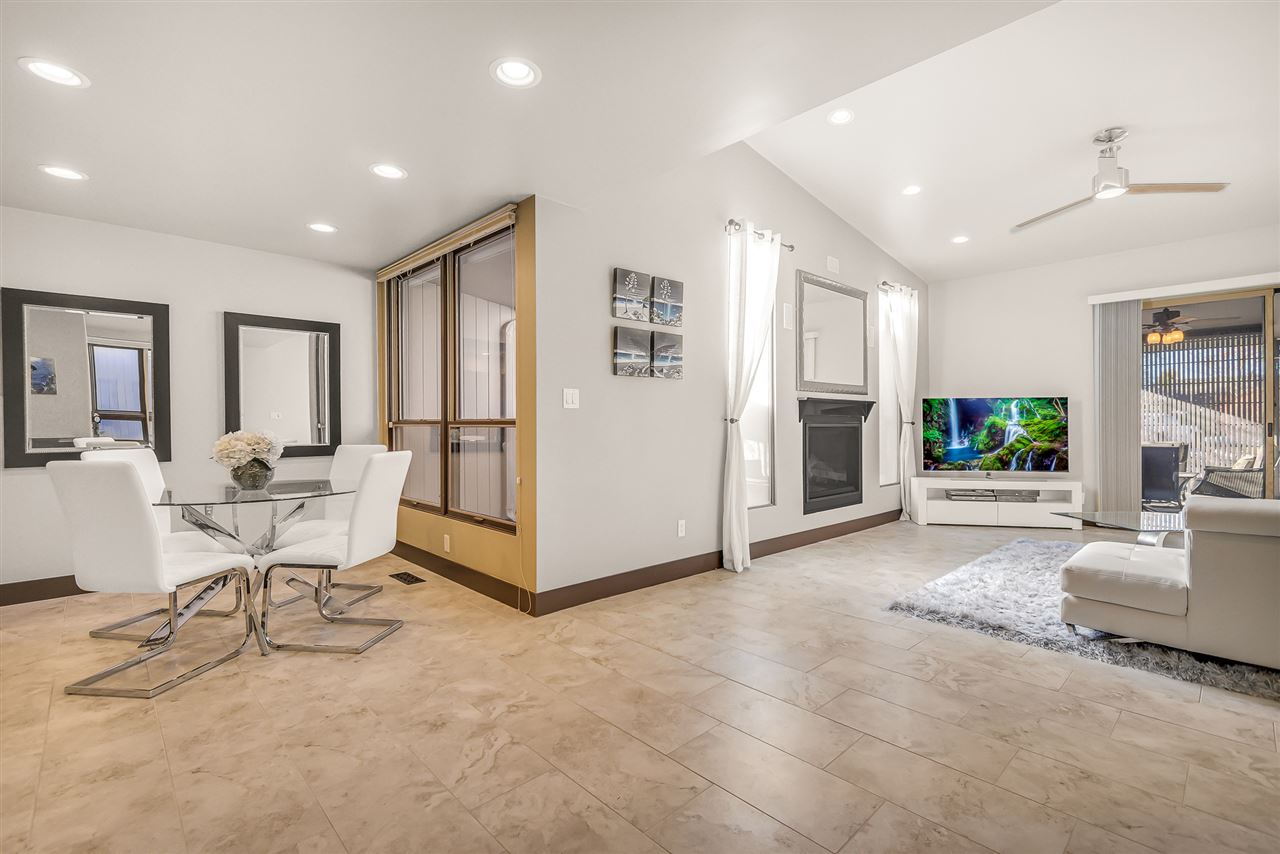 702 Golfmore Drive, Unit C Grand Junction, CO 81506 - Photo 6 of 21 a living room with furniture a flat screen tv and a refrigerator