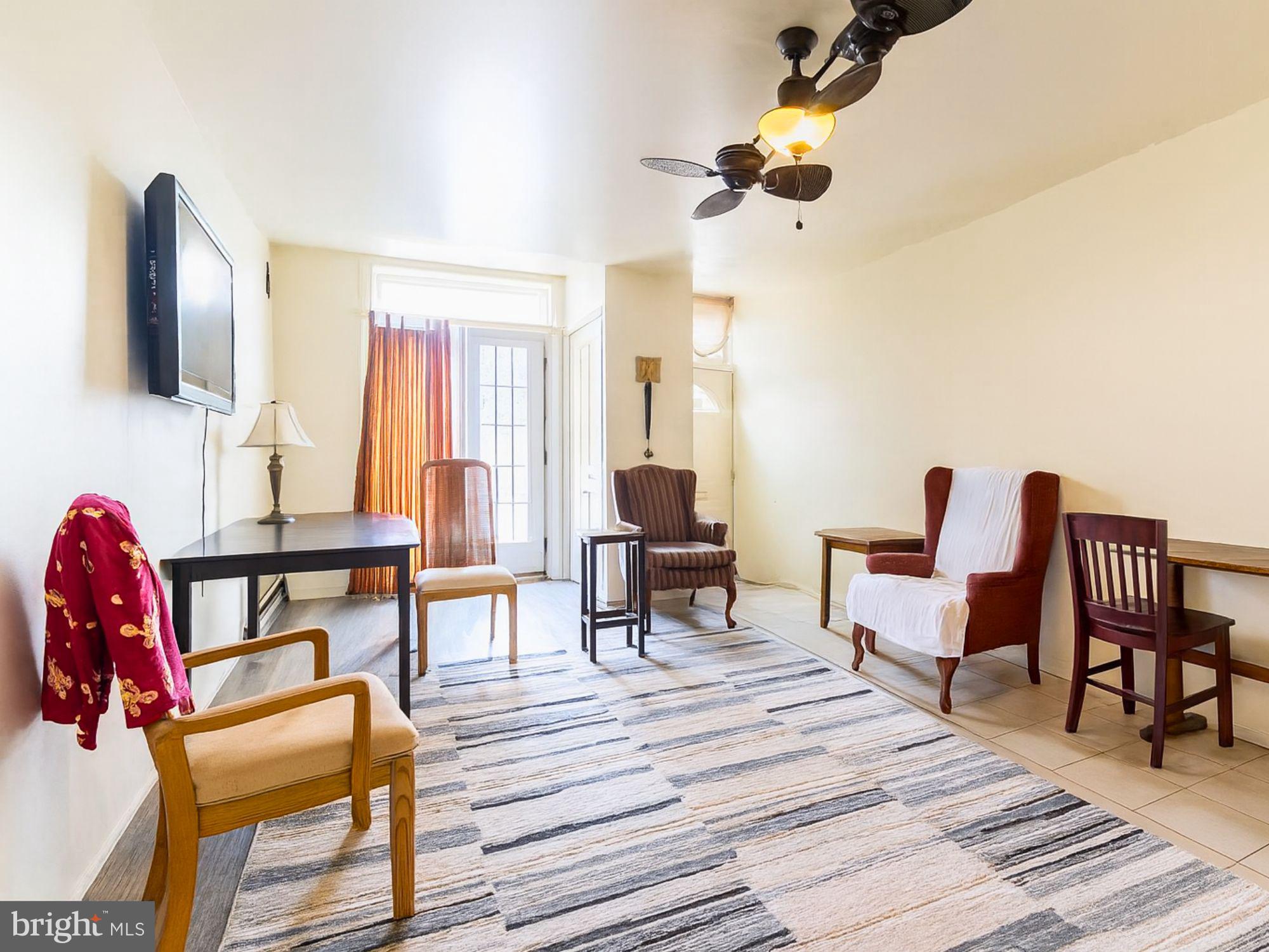 2715 East Madison Street Baltimore, MD 21205 - Photo 2 of 11 a living room with furniture and a flat screen tv