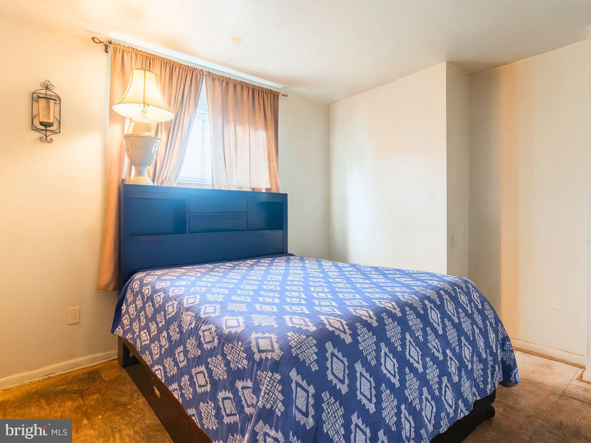 2715 East Madison Street Baltimore, MD 21205 - Photo 4 of 11 a bedroom with a bed and window