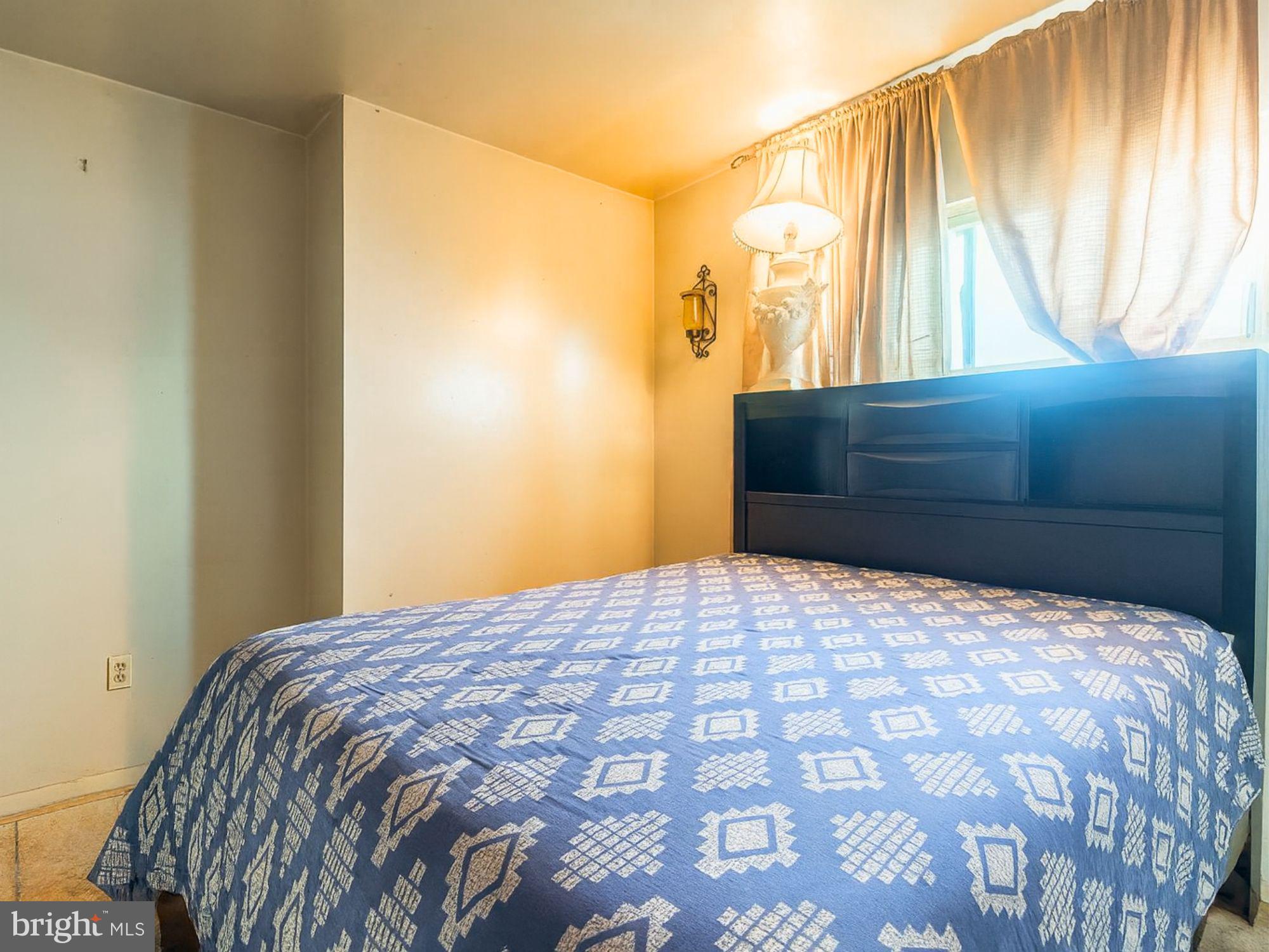 2715 East Madison Street Baltimore, MD 21205 - Photo 5 of 11 a bedroom with a bed and a dresser