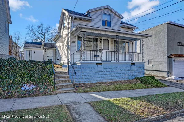 front view of a house with a bench