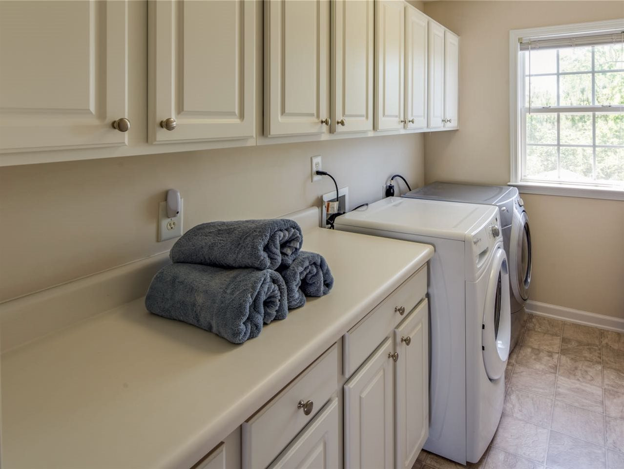 7780 Silver View Lane Raleigh, NC 27613 - Photo 19 of 30 The laundry room is perfectly located on the second level, adjacent to the four bedrooms. Smart. Laundry room
