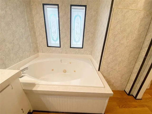 a view of a room with wooden floor and closet area