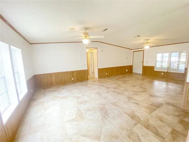 a view of a kitchen with a sink and a refrigerator