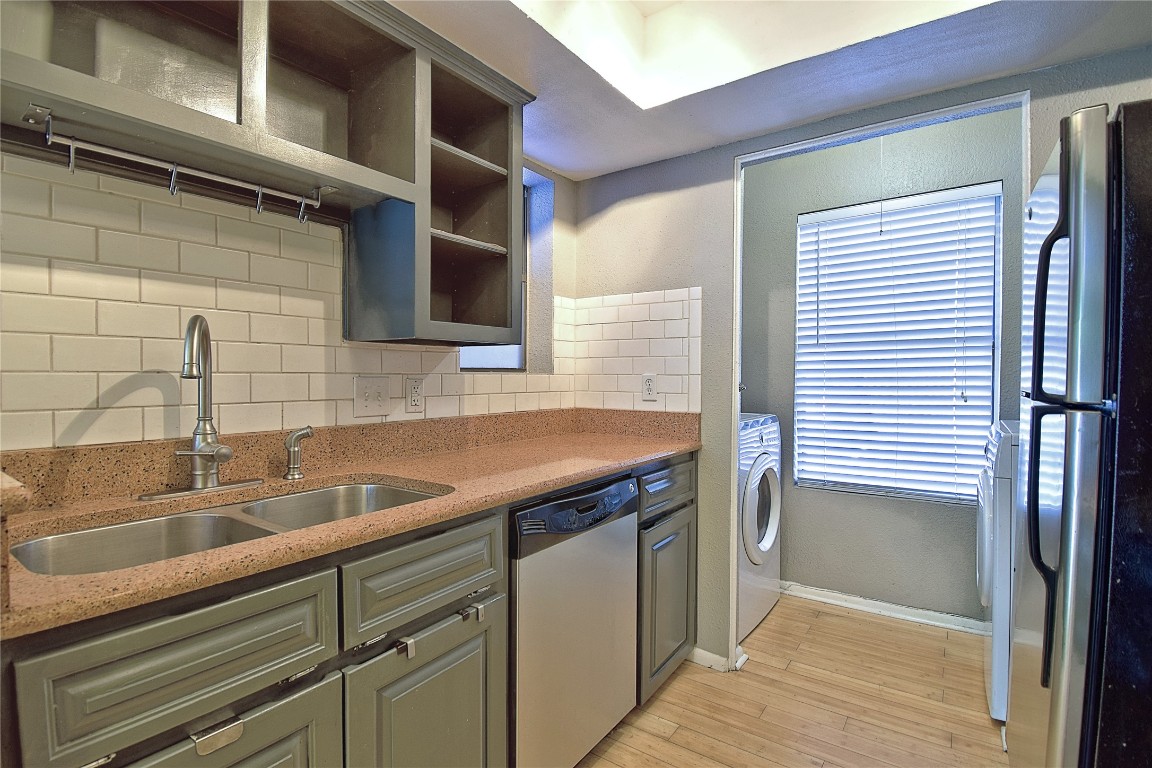 7635 Guadalupe Street, Unit 803 Austin, TX 78752 - Photo 7 of 16 a kitchen with a sink and cabinets